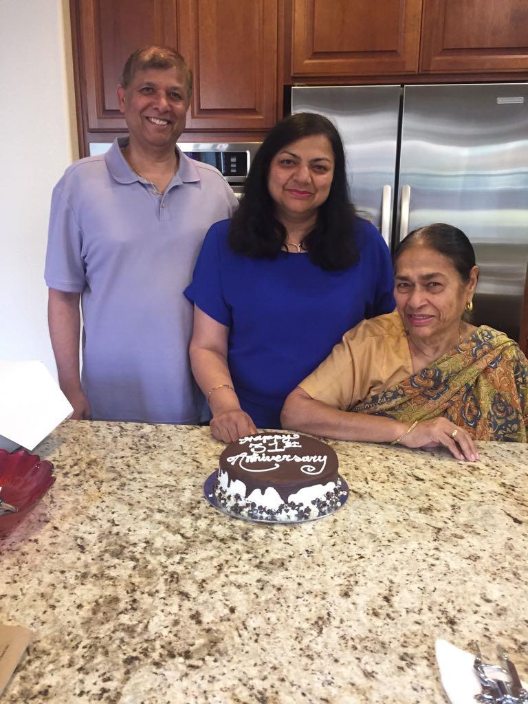 Family gathers around a beautifully decorated cake to celebrate a special occasion at home.