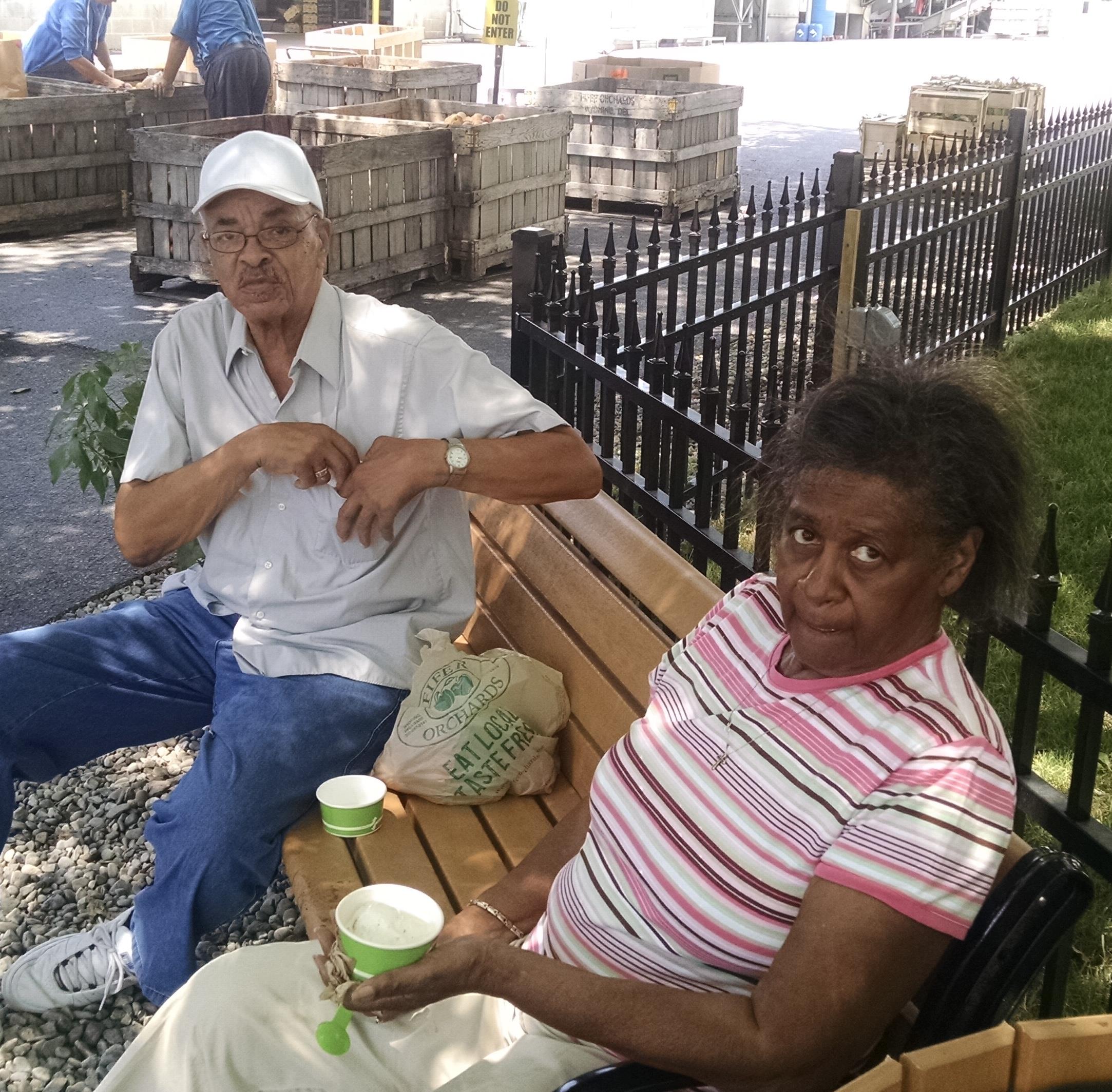 A man and woman sitting on a bench