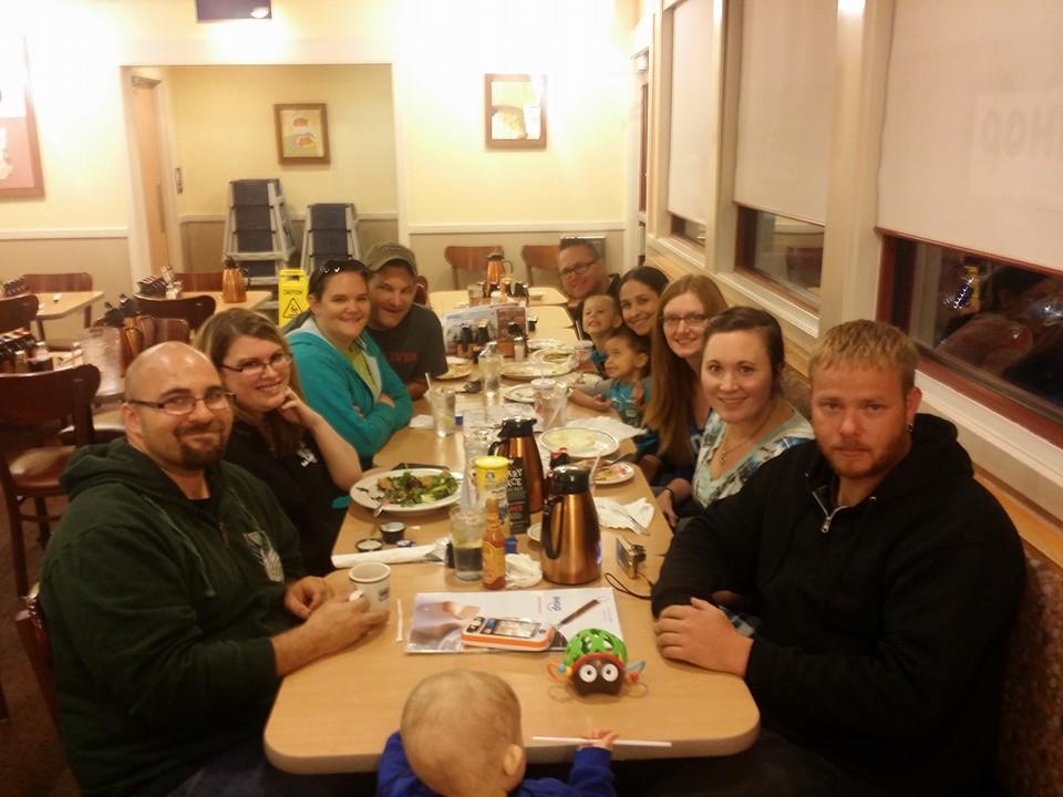 Family members gather around the table, sharing a meal and laughter in a relaxed vibe.