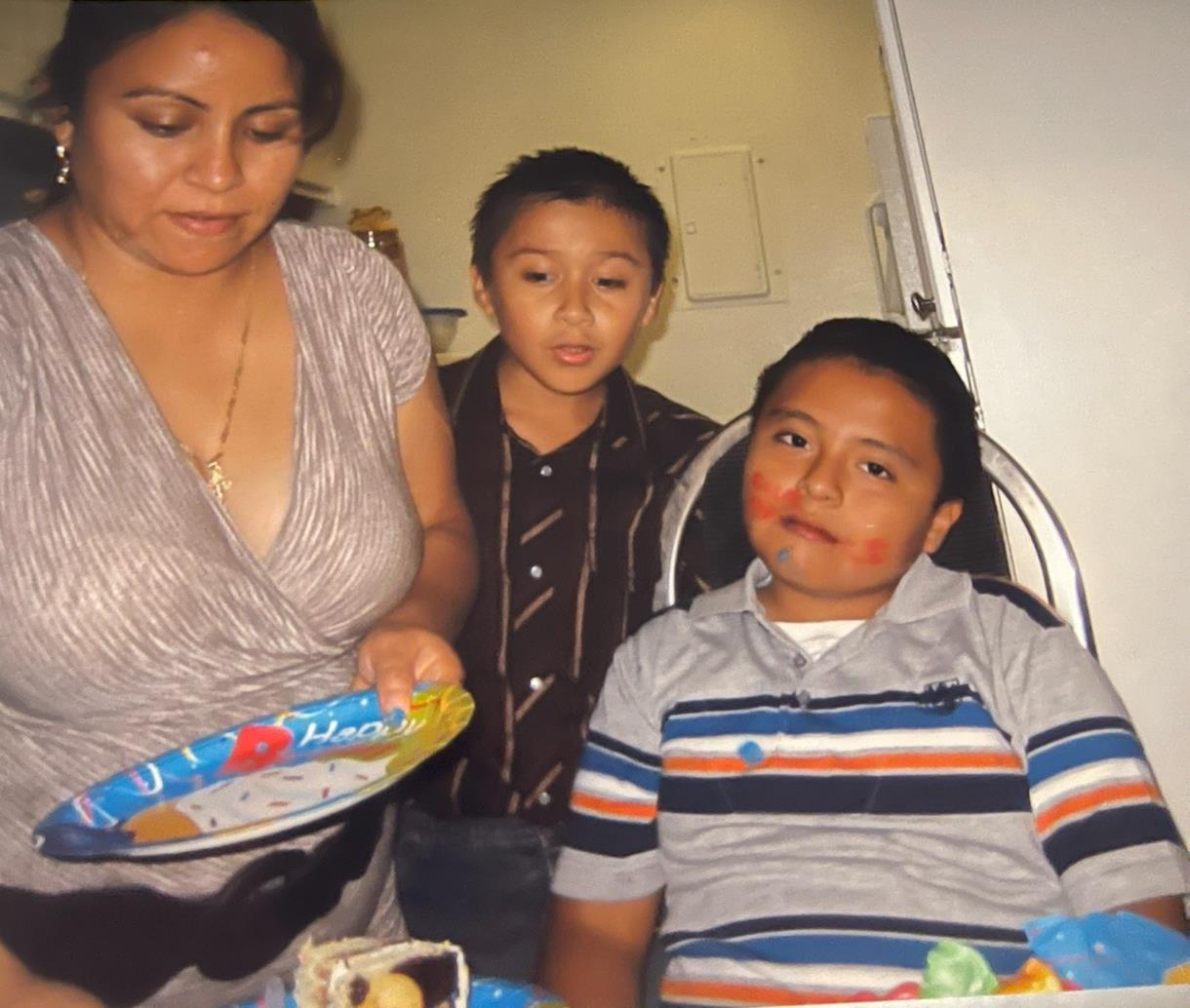 A woman serves food to her two children during a joyful family gathering at home.