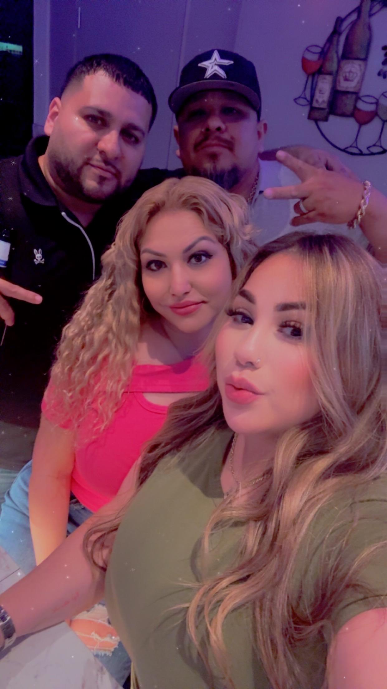 Group of friends posing joyfully together at a fun event in an energetic atmosphere.