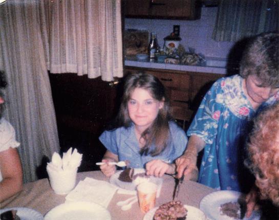 A woman cutting a cake