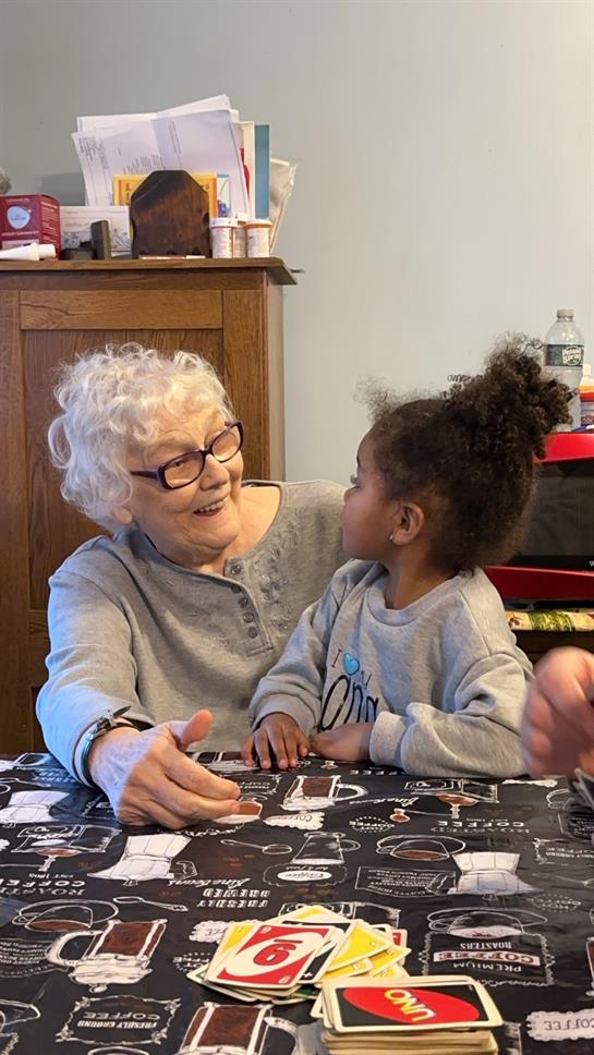 An older woman and a young girl sitting at a table