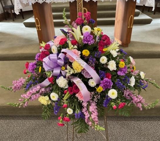 A bouquet of flowers on a stand