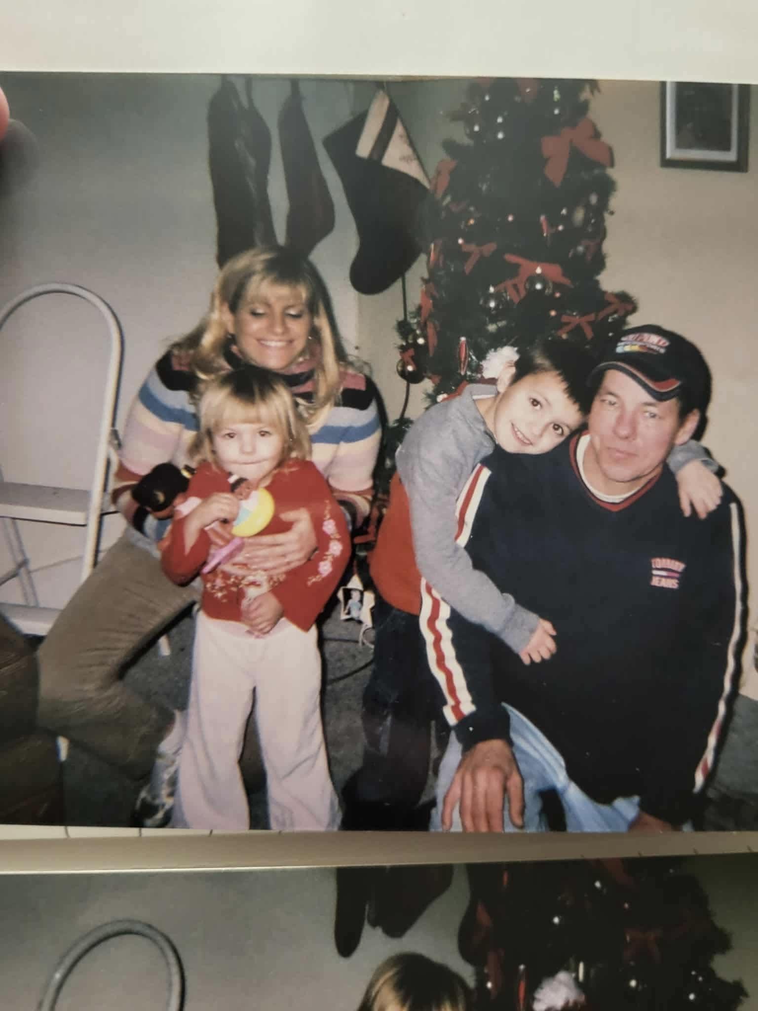 A happy family celebrates Christmas, sharing smiles and laughter together.