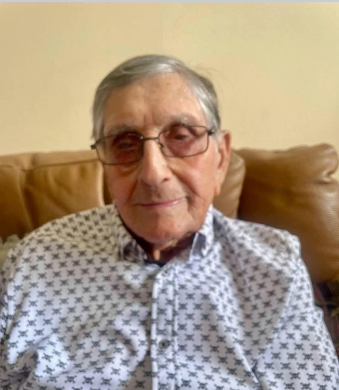 An old man sitting on a couch