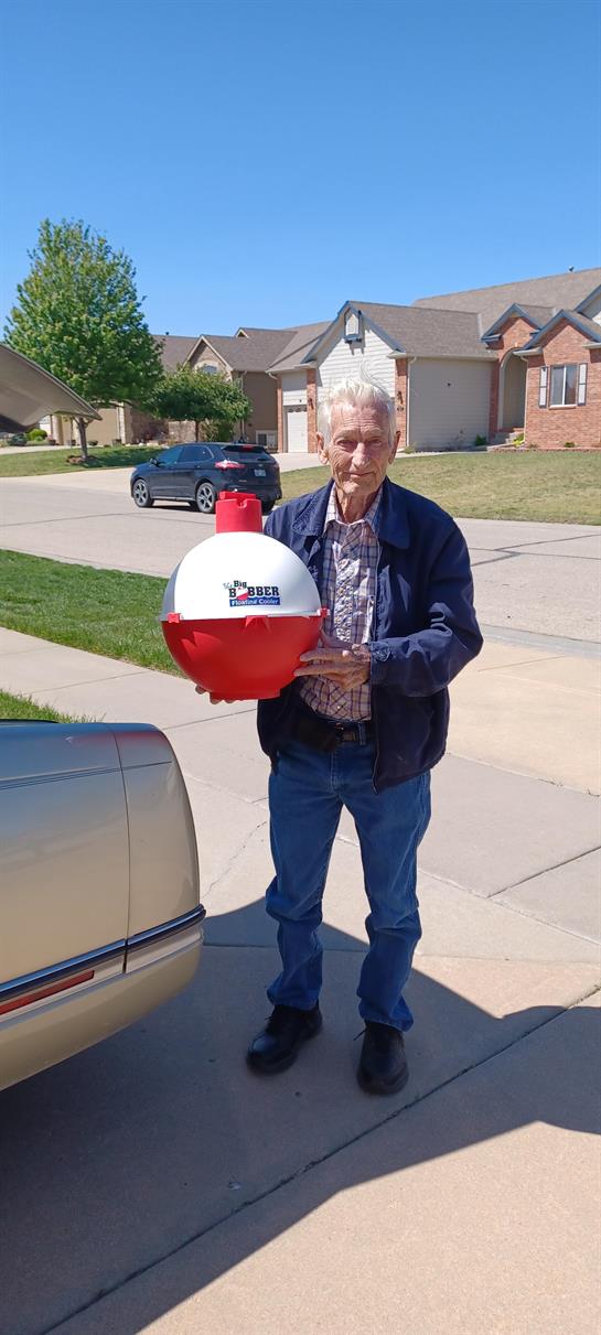 An old man holding a fishing float