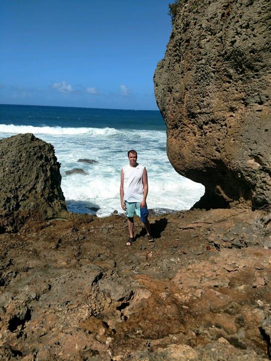 A man standing on a rocky beach