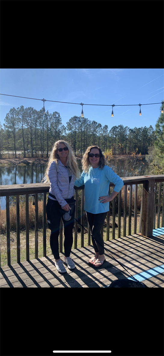 Two women standing on a deck
