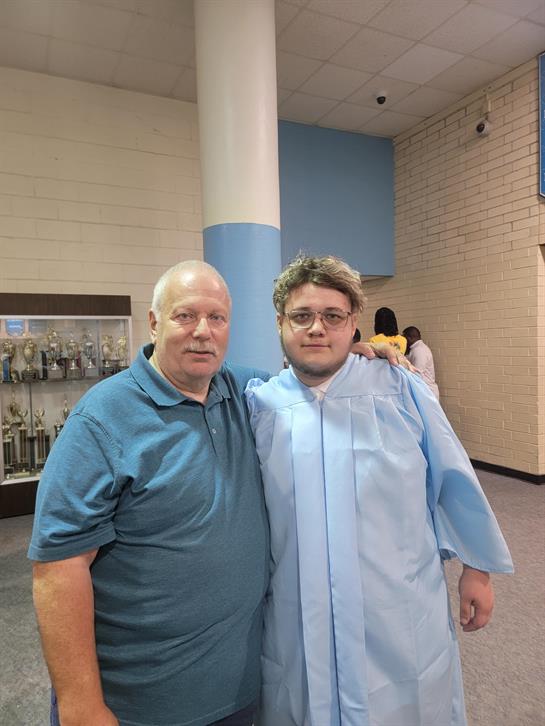 A man standing next to a man in a blue robe
