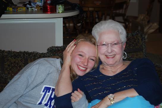 A woman and a woman sitting on a couch