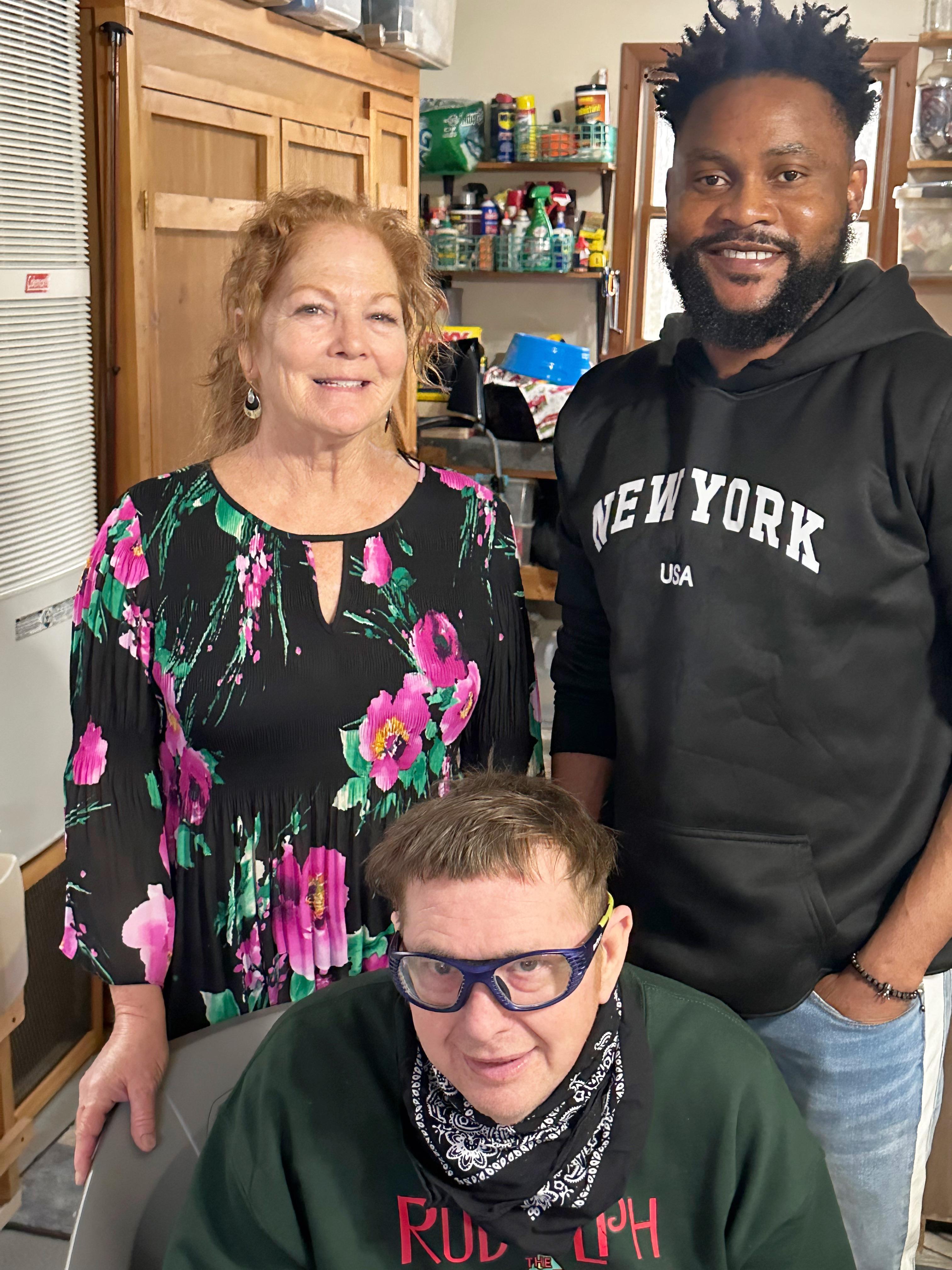 Three friends enjoy a lighthearted moment together indoors with bright decor.
