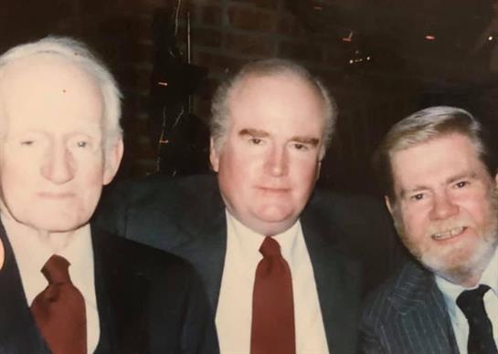 A group of men posing for a photo