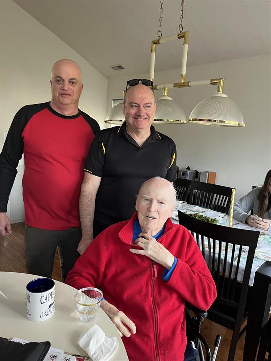 A group of men standing around a table