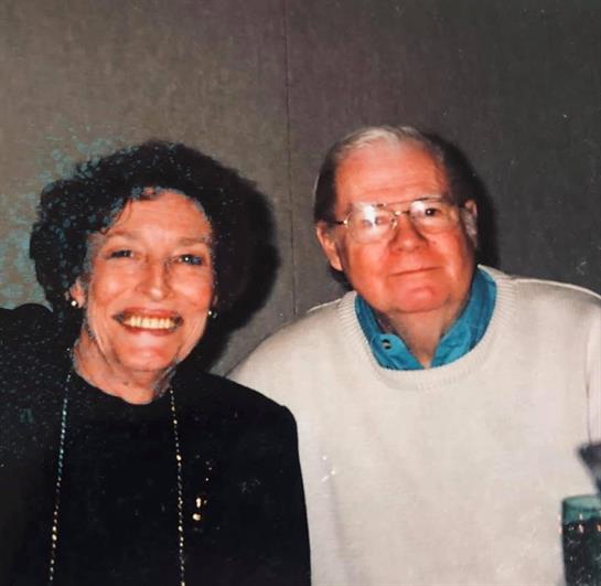 A man and woman smiling at camera
