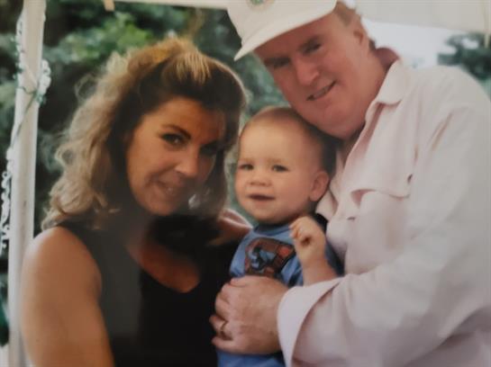 A man and woman holding a baby