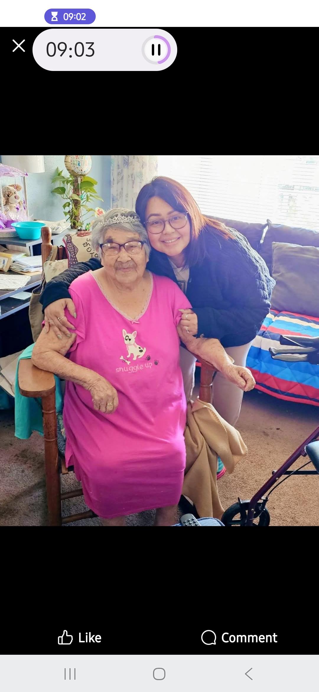 Family members enjoy warm moment together in a bright living room filled with personal items.