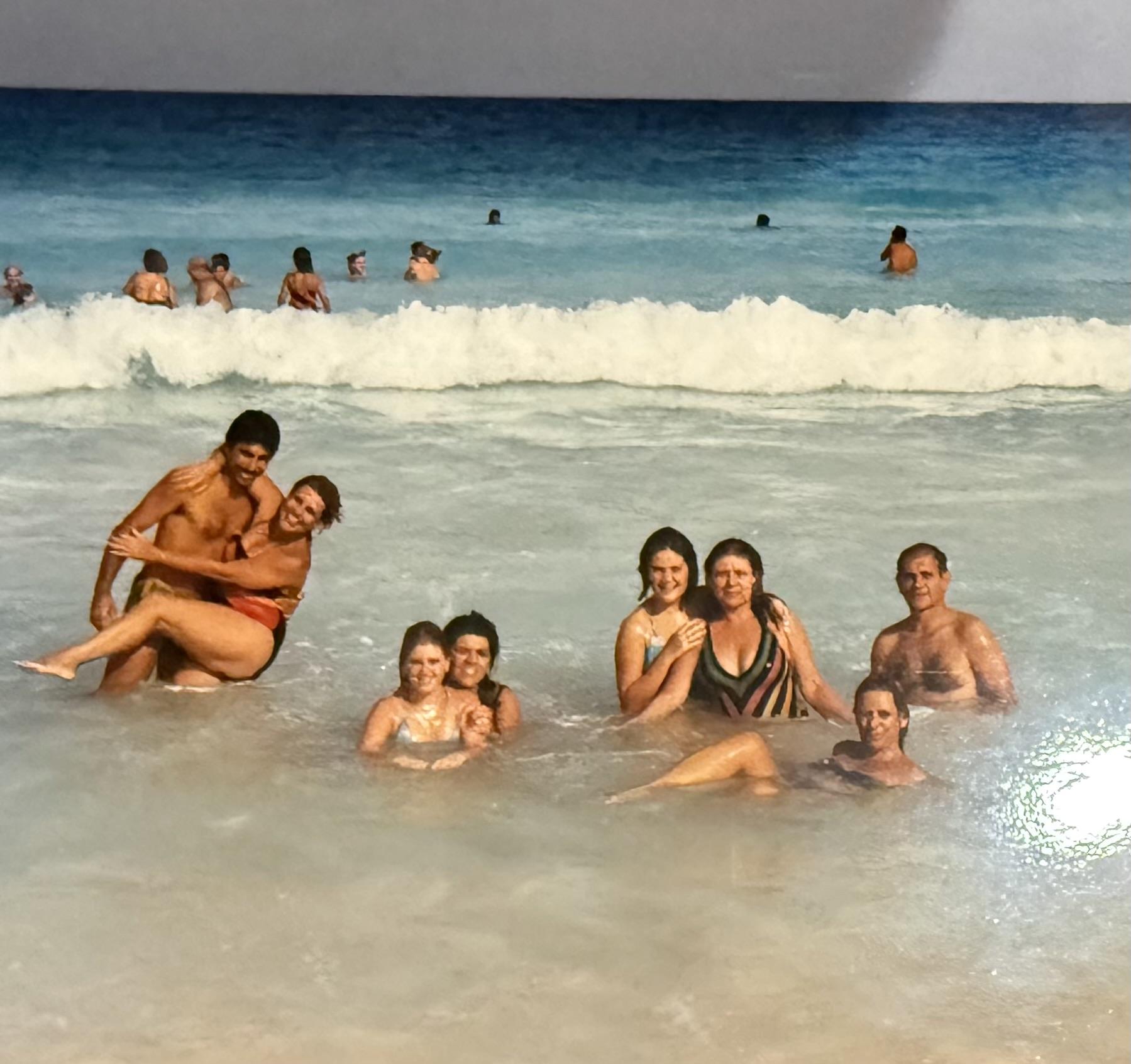 Friends are having fun in the ocean, splashing in the water and enjoying a sunny beach day.