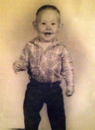 A baby in a plaid shirt