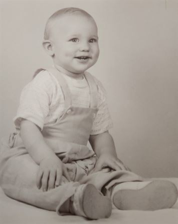A baby sitting on the floor