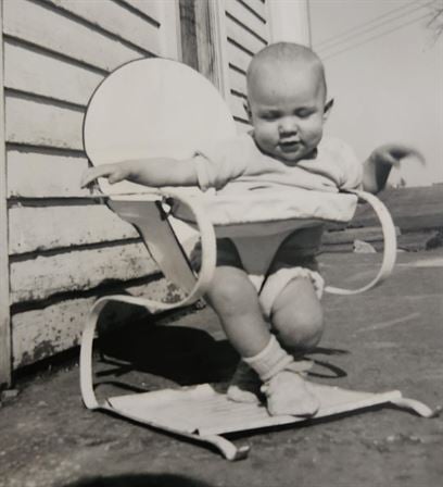 A baby sitting in a chair