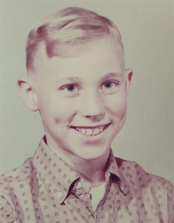 A boy smiling for a picture