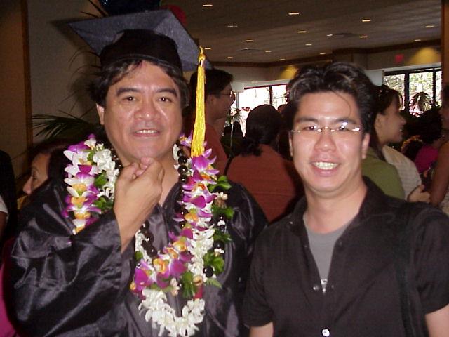 A man in a graduation gown and cap posing for a picture