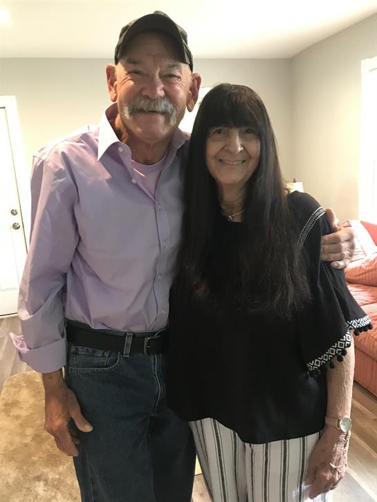 A man and woman posing for a picture