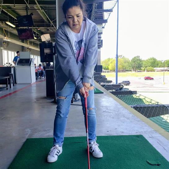 A woman holding a golf club