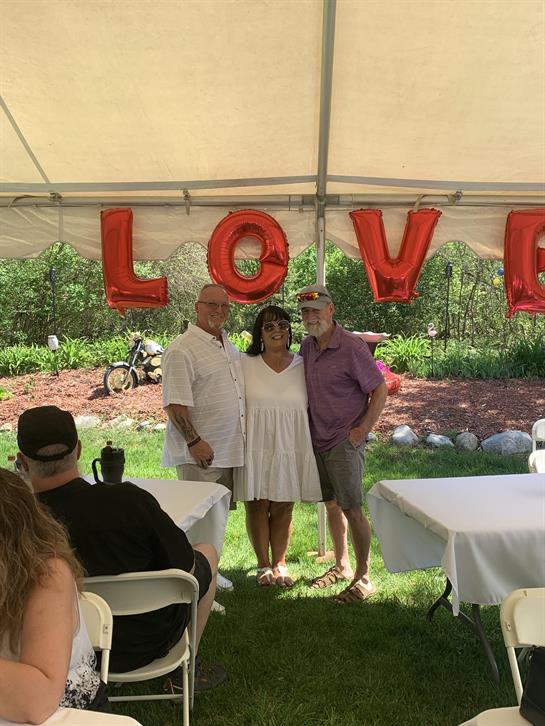 A group of people standing under a tent
