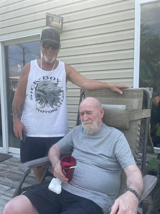 Two men sitting in a chair