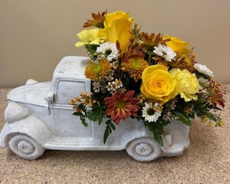 A white car with yellow flowers