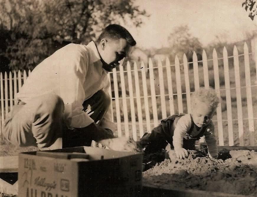A man and child playing in a box