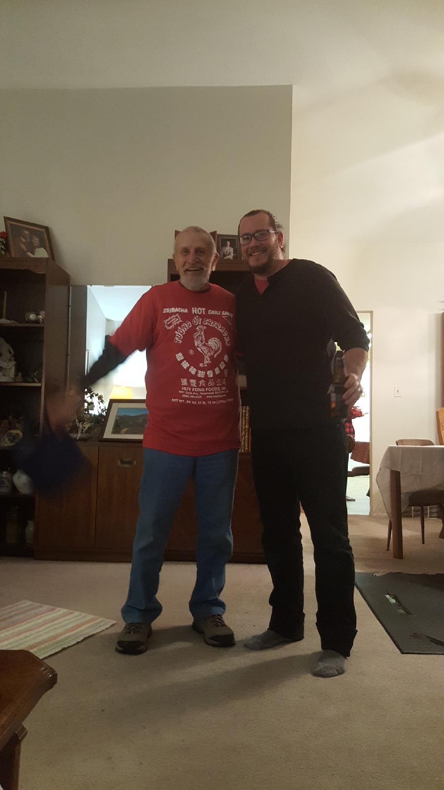 Two men standing together in a room