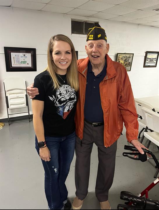 A woman hugging an old man