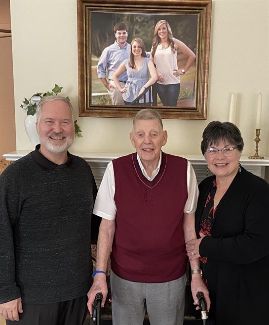 A group of people standing in front of a picture