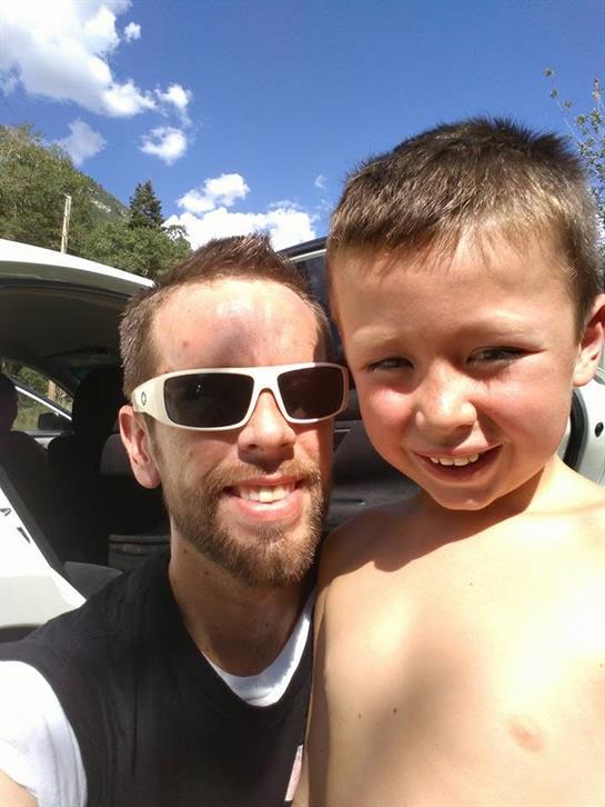 A man and child posing for a selfie
