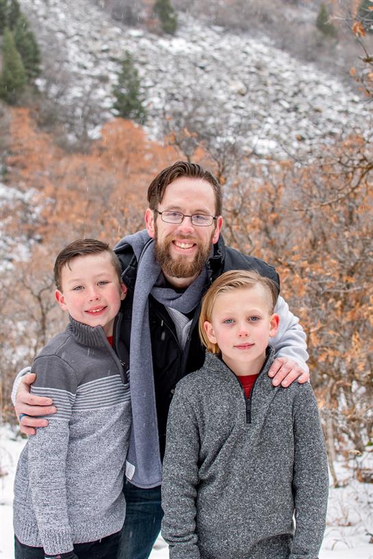 A man and two boys posing for a picture