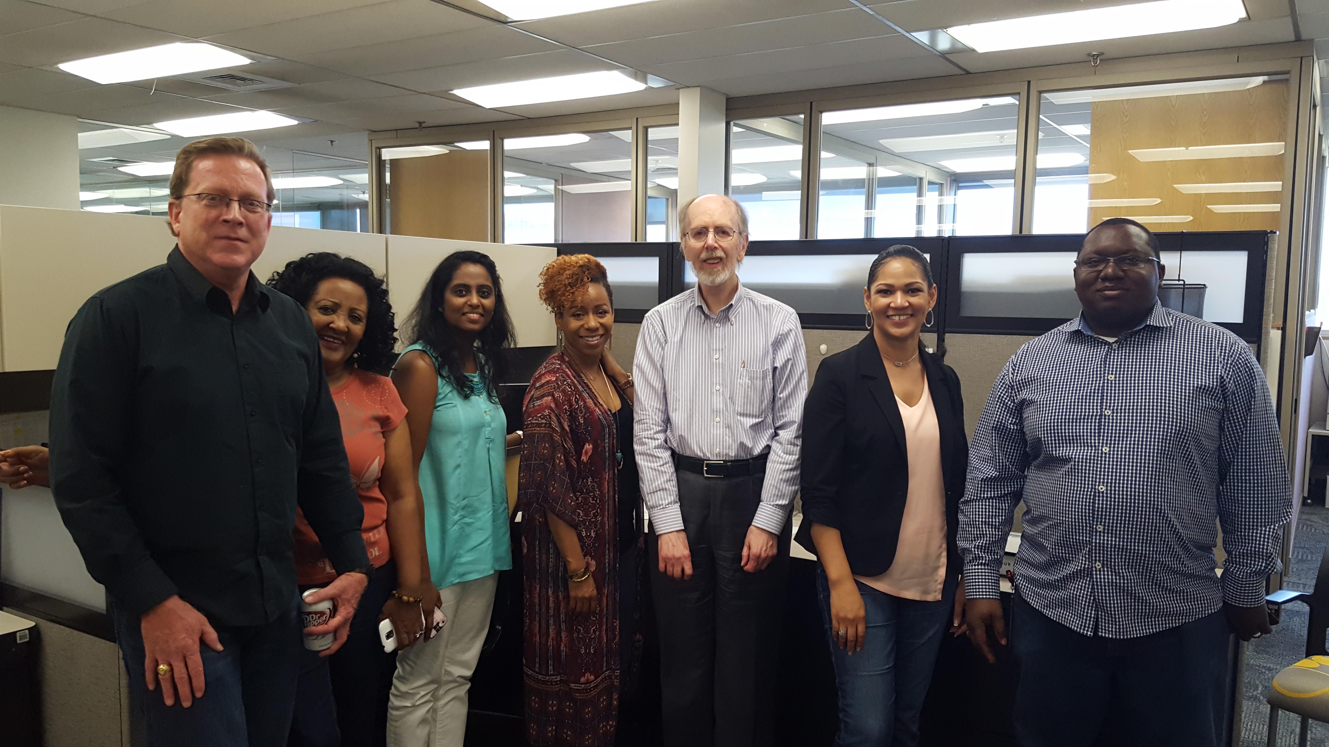 People gather in an office space to talk and share ideas with each other during work hours.
