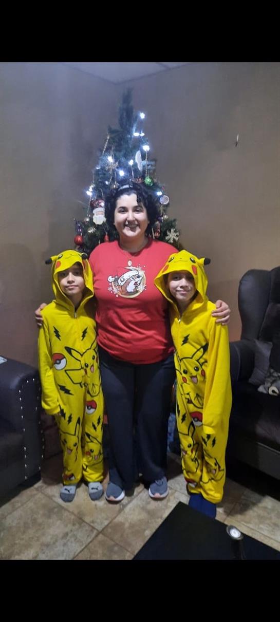 A woman and two boys posing for a picture