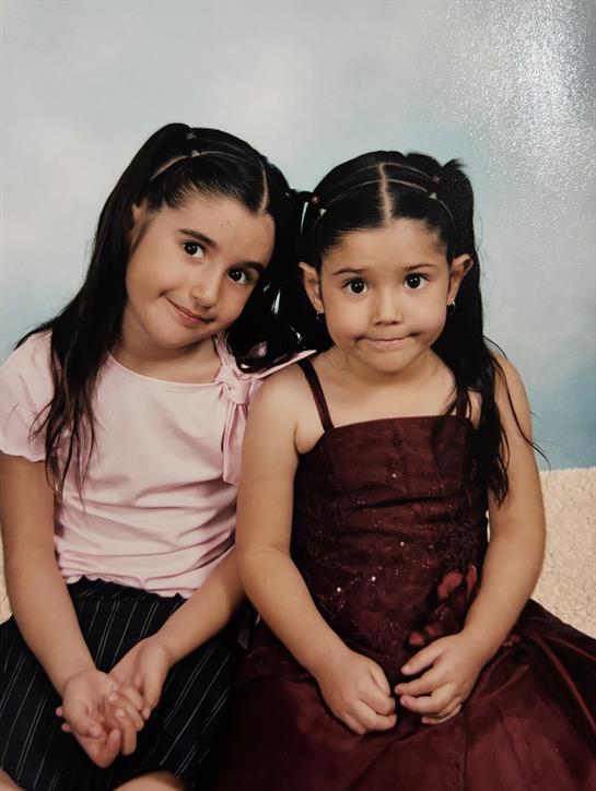Two girls sitting together smiling