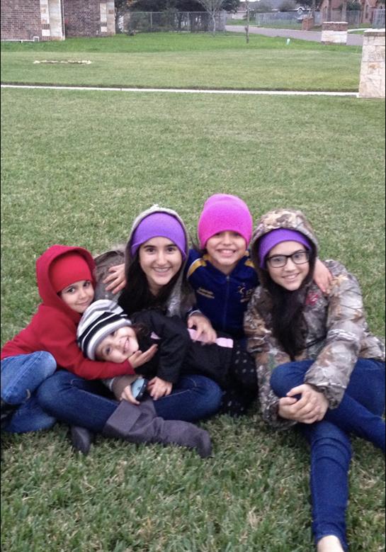 A group of children sitting on grass