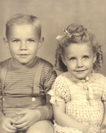 A boy and girl posing for a picture