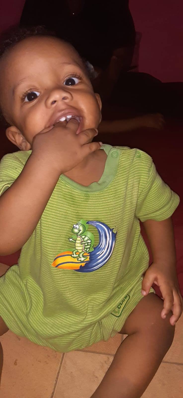A baby biting his finger