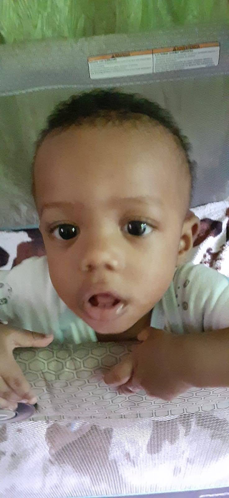 A baby looking up at the camera