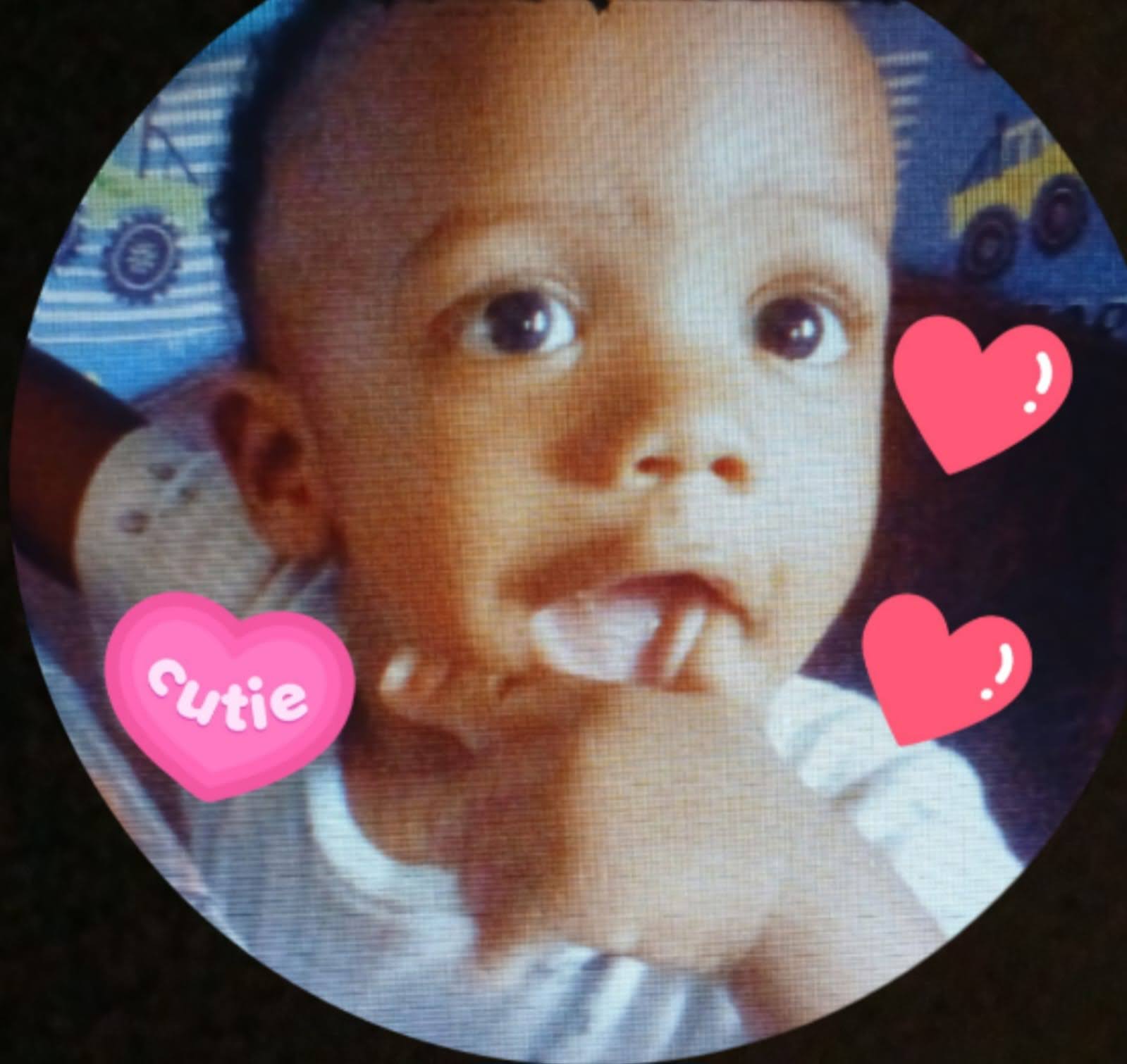 A baby with fingers in mouth
