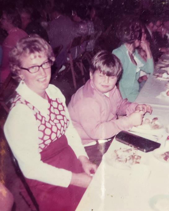 A woman and a boy sitting at a table