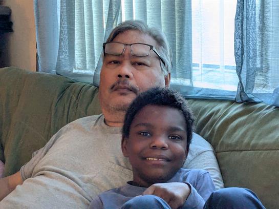 A man and boy sitting on a couch