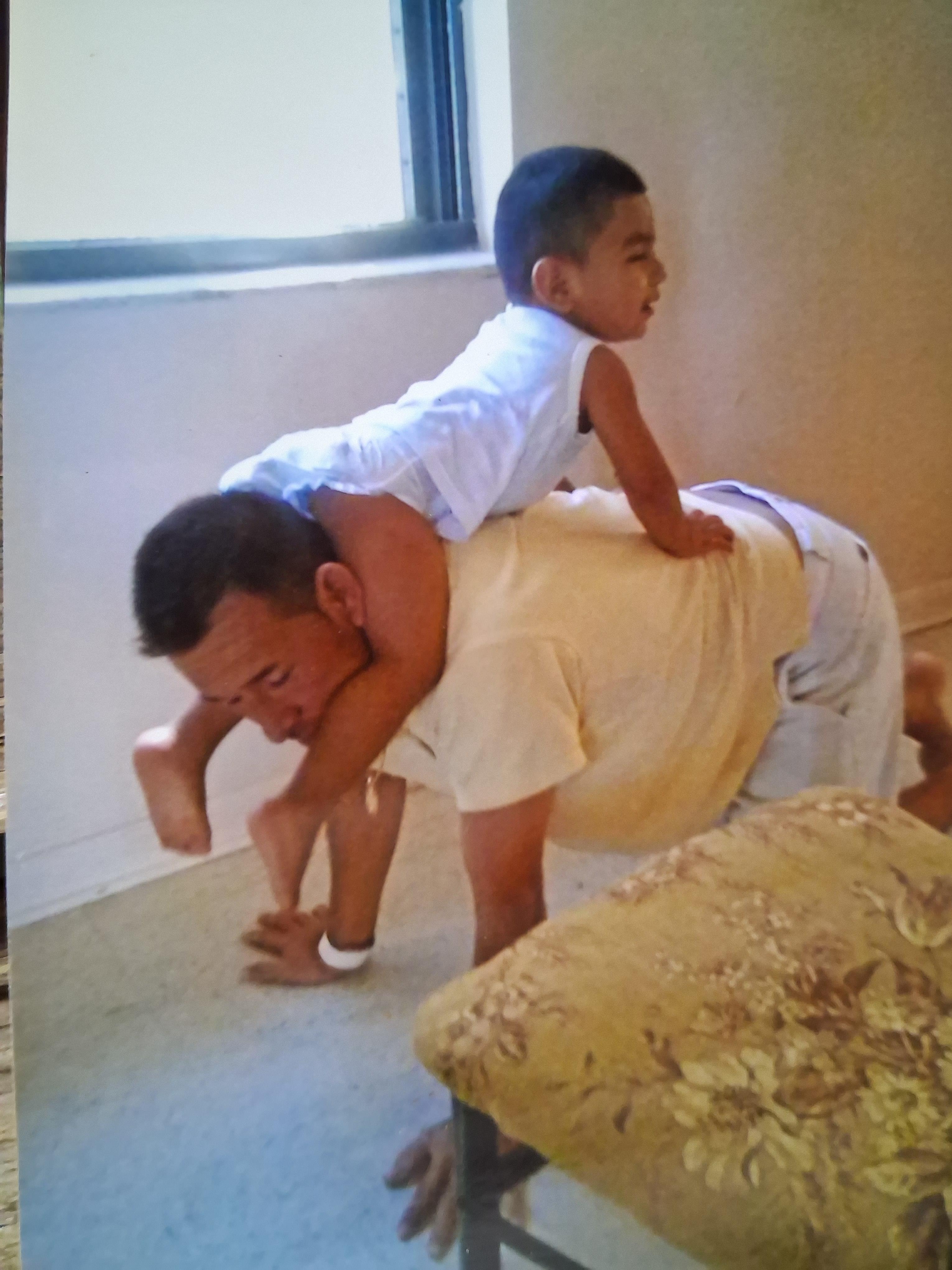 A man carrying a child on his back