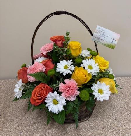A basket of flowers with a card
